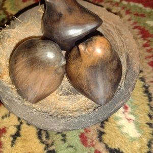 Wooden birds in wooden nest